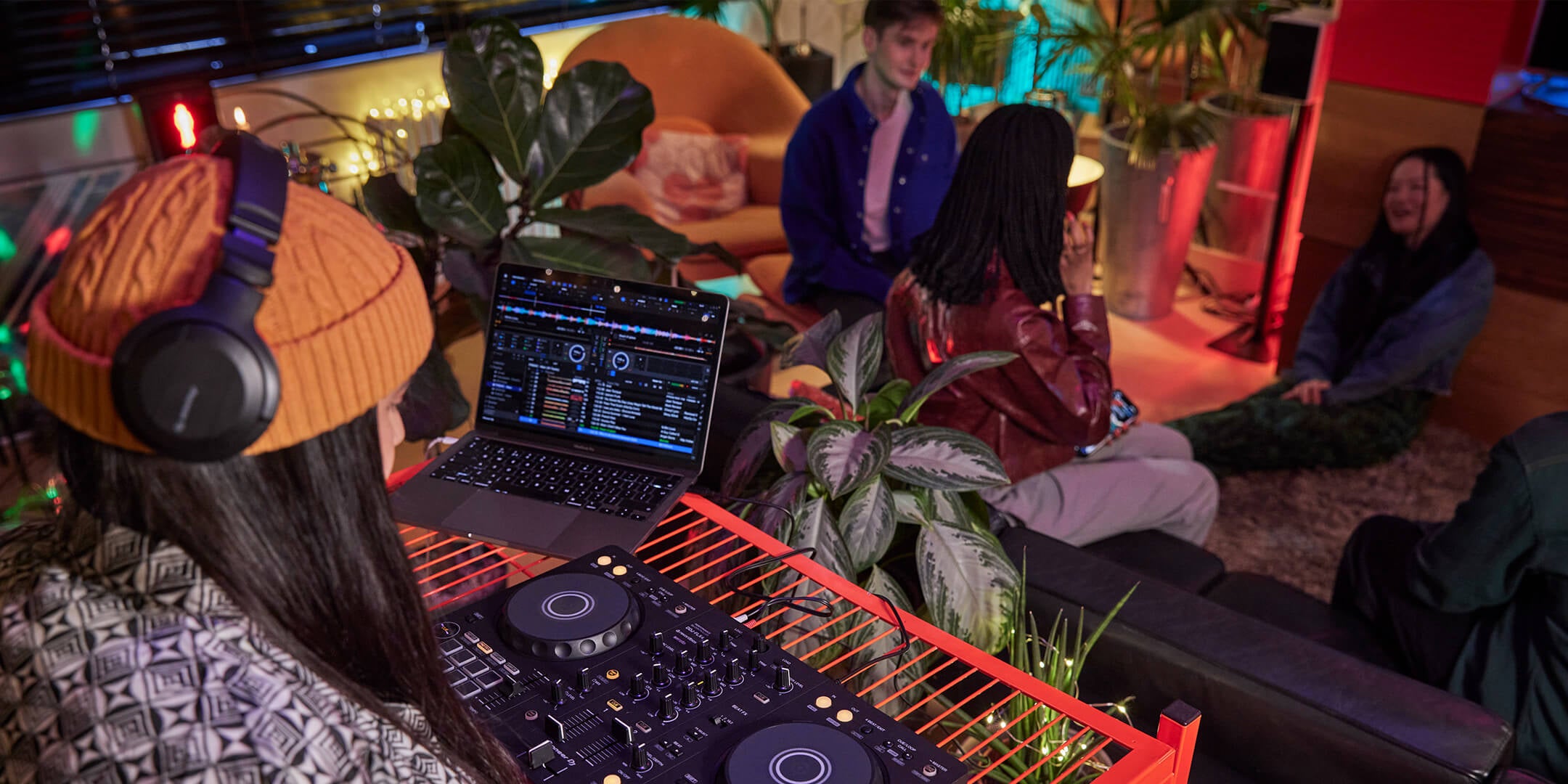 A DJ playing a set to friends in relaxed surroundings